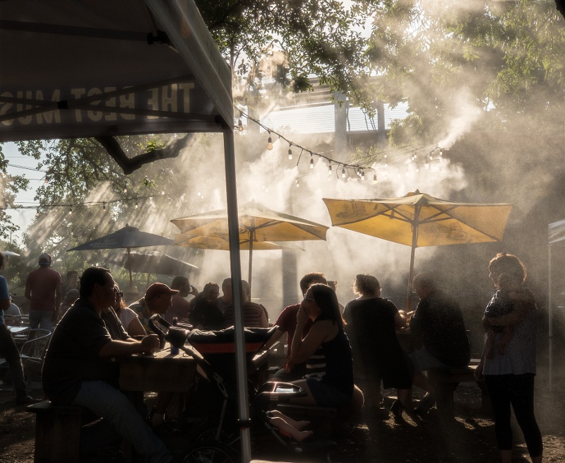 Sprinklers moist a crowd at live music venue by Michael Discenza on Unsplash-1